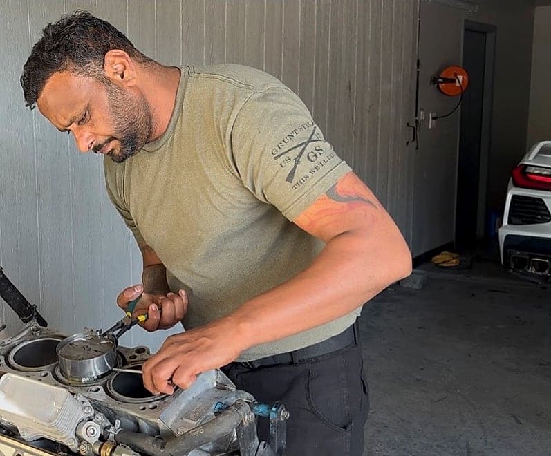 Nirmal, owner of Shiv Auto Service, repairing an engine at the Tracy shop